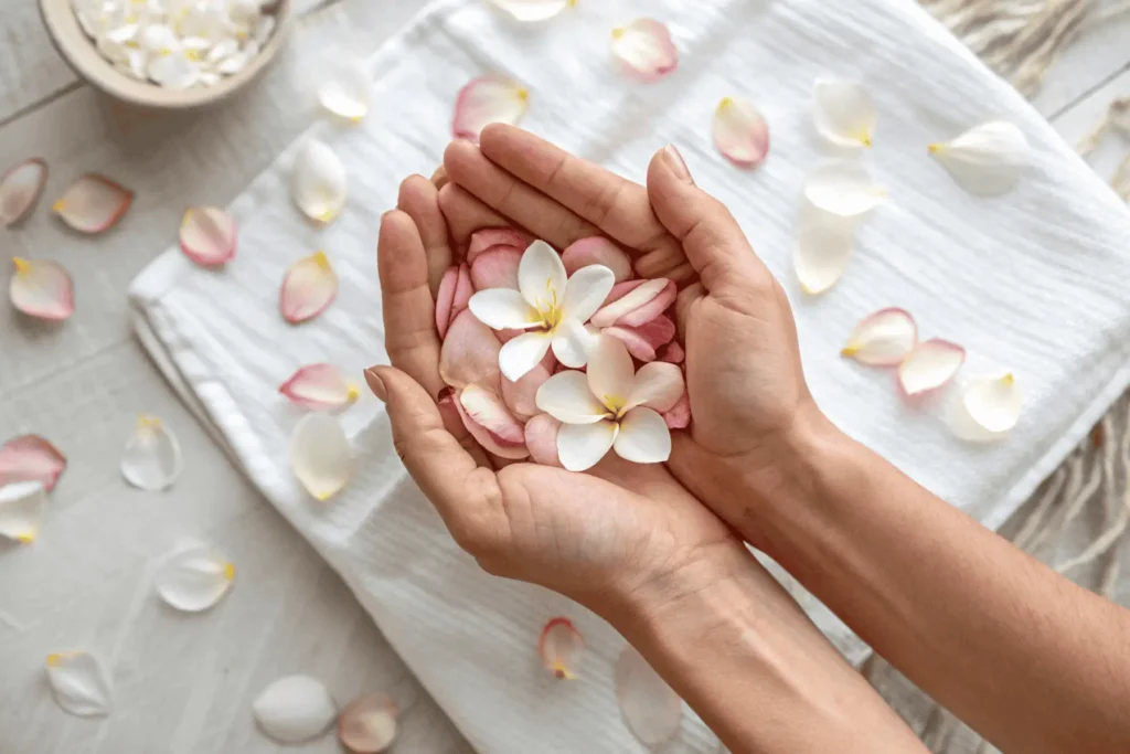 Close-up of gentle hands holding rich earth, with a single new sprout emerging into the light. Symbolizes planting a seed of kindness for a positive mindset.